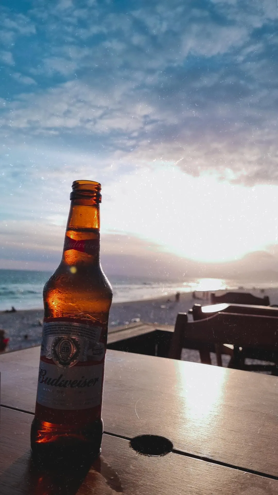 beer on the top of a table, in a  beach